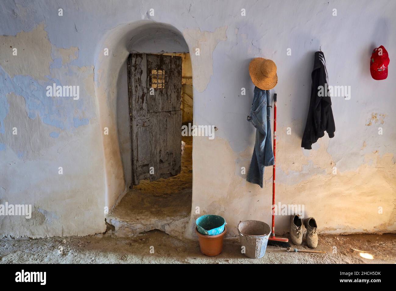 Still life with work clothes, straw hat, bucket, broom and work shoes, renovation of a cave house, Andalusia, Spain Stock Photo