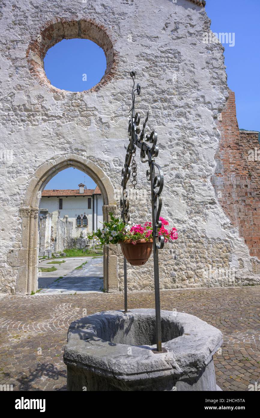 Fountain at the ruins of the church that collapsed in the 1976 earthquake, Venzone, province of Udine, Italy Stock Photo