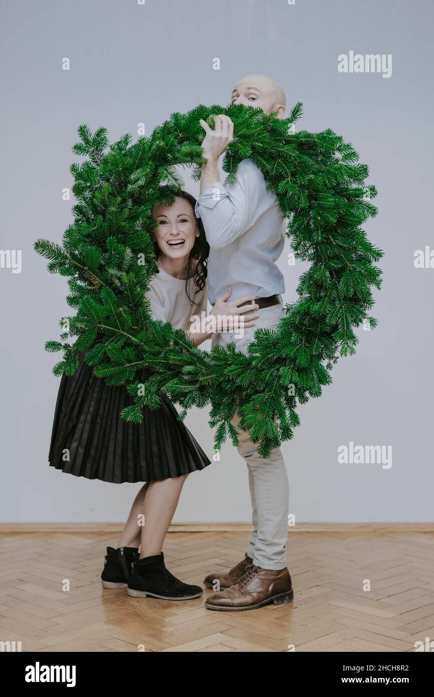 Man and woman with fir wreath Stock Photo