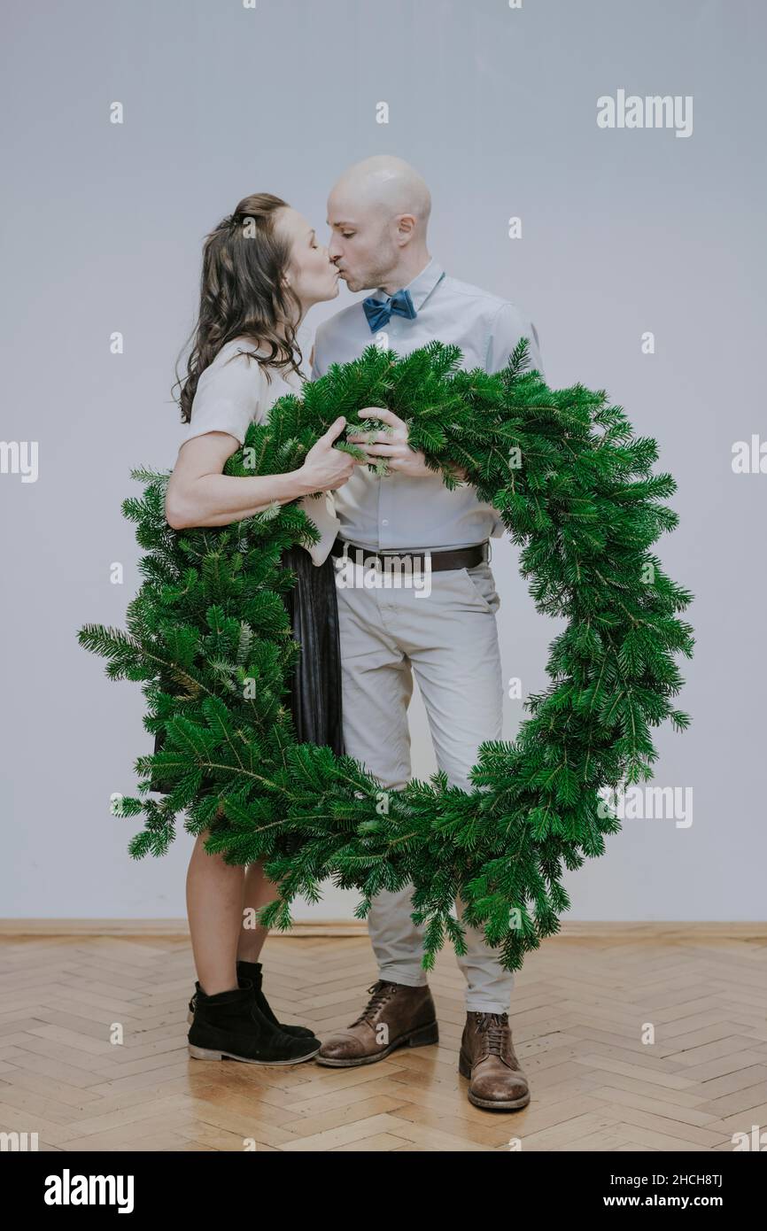 Man and woman with fir wreath Stock Photo