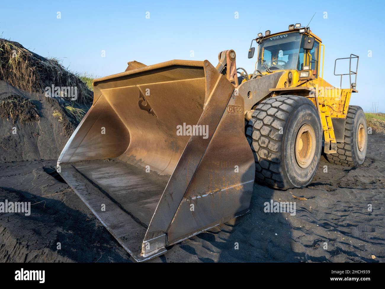 Excavator standing by the road, Iceland Stock Photo