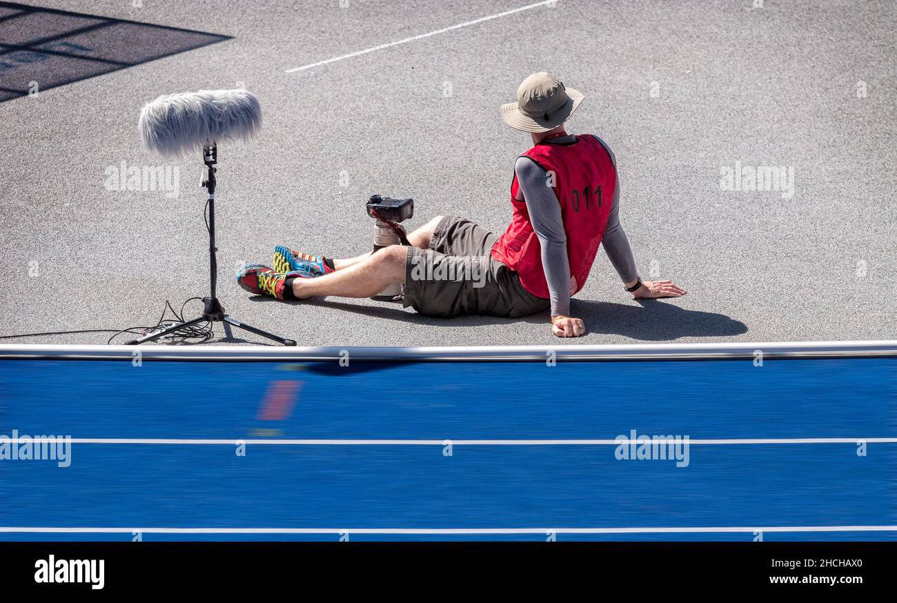 Photographer with red waistcoat during an athletics event at the Olympiastadion, Berlin, Germany Stock Photo