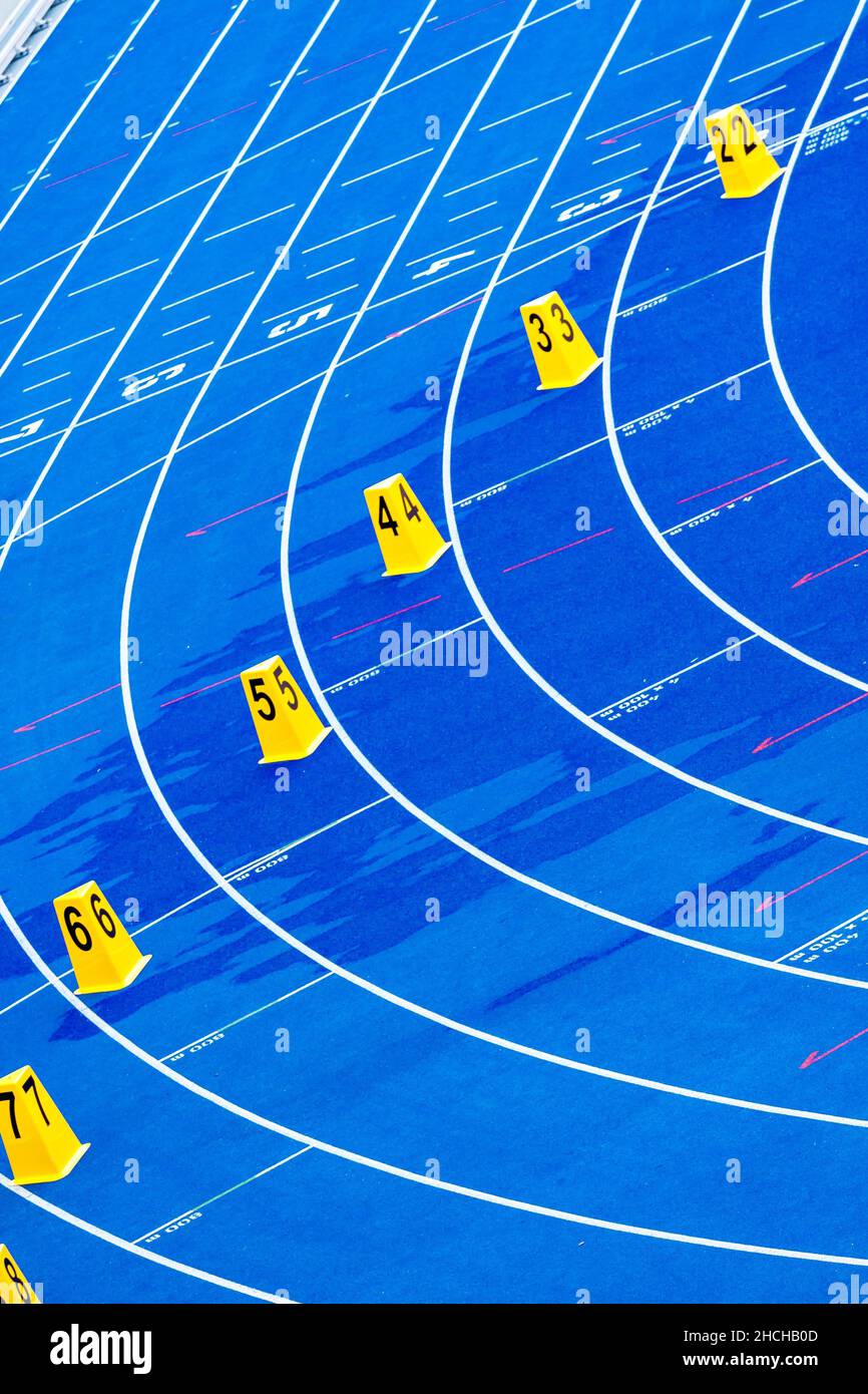 Blue tartan track with yellow start numbers at the Olympiastadion, Berlin, Germany Stock Photo