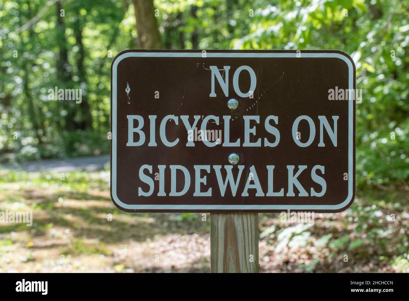'No Bicycles on Sidewalks' sign in campground Stock Photo