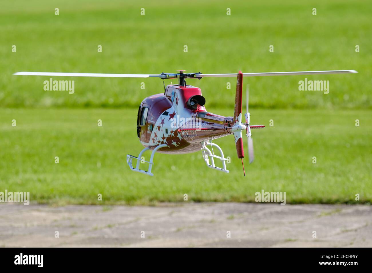 Neunhof, Germany - September 02, 2021: Rear view of a radio controlled scale model of a AS350 Ecureuil helicopter with Air Zermatt design is hovering Stock Photo