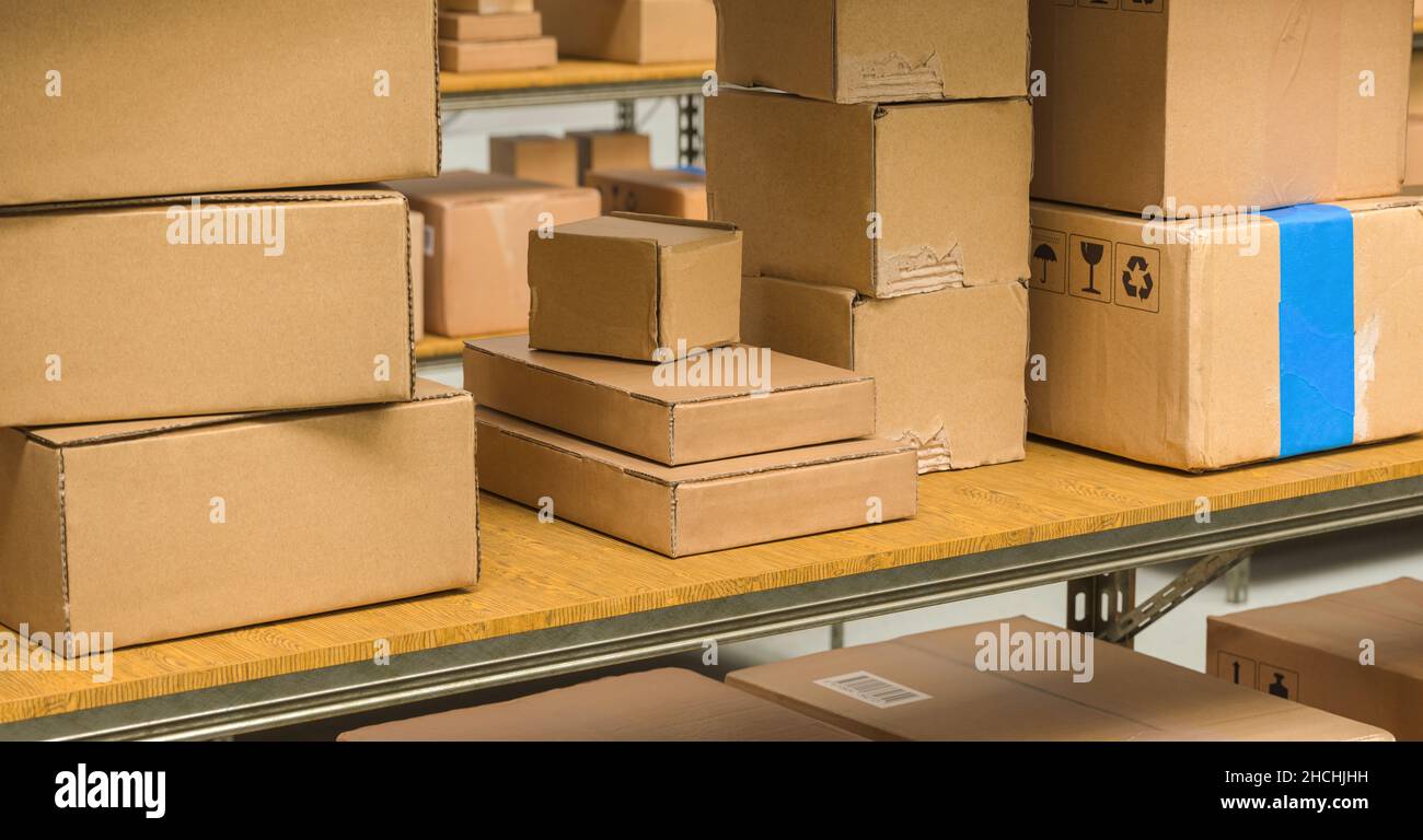 different cardboard boxes on shelves in a warehouse, Packed courier