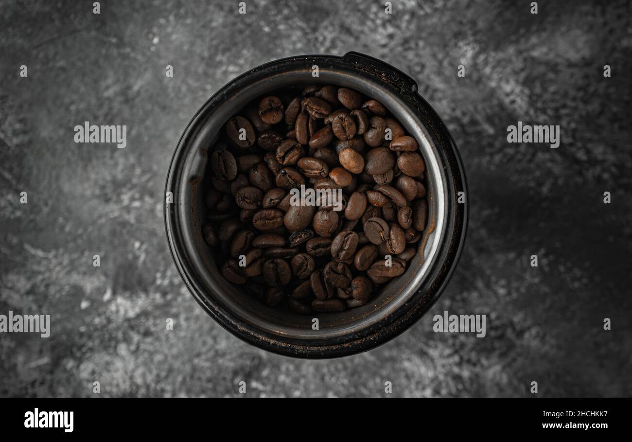 Top view shot of a bunch of coffee beans in a mug on a table Stock Photo
