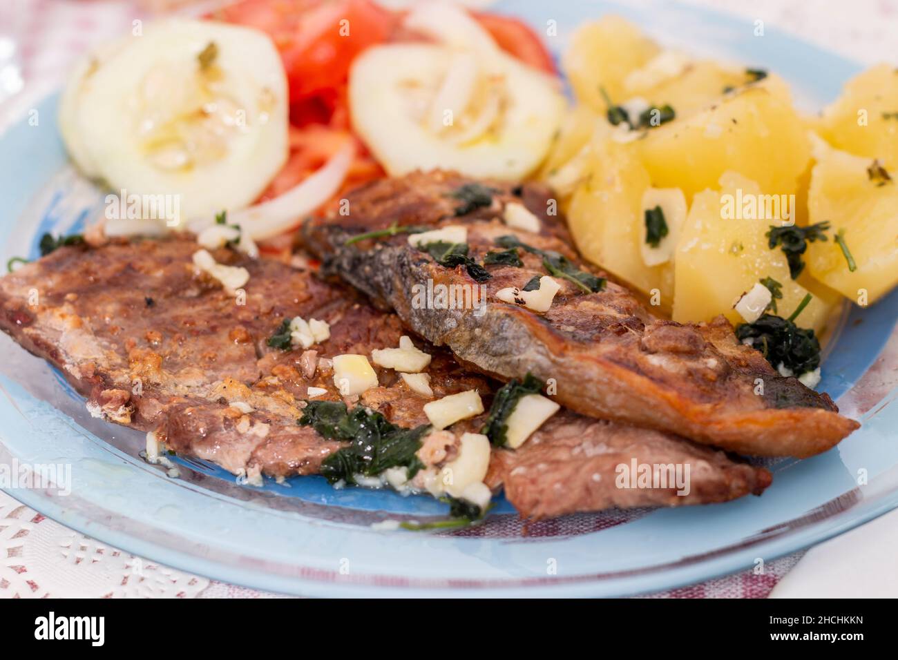 Portuguese meal dish of Grilled tuna belly fish with potatoes and