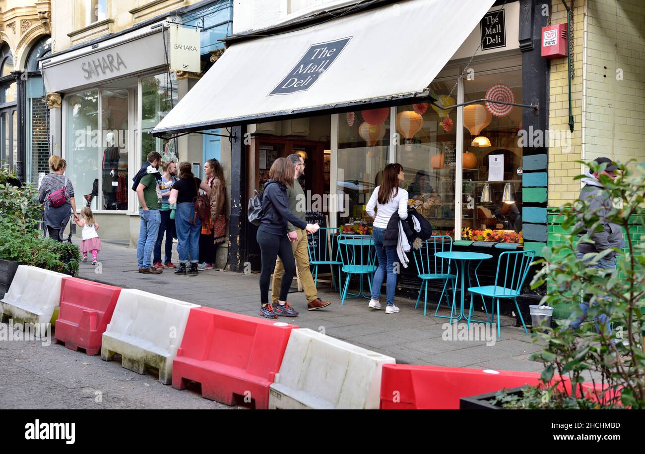 Shops, restaurants along The Mall being pedestrianised with planters and eating out along road with tables and chairs, Clifton, Bristol Stock Photo