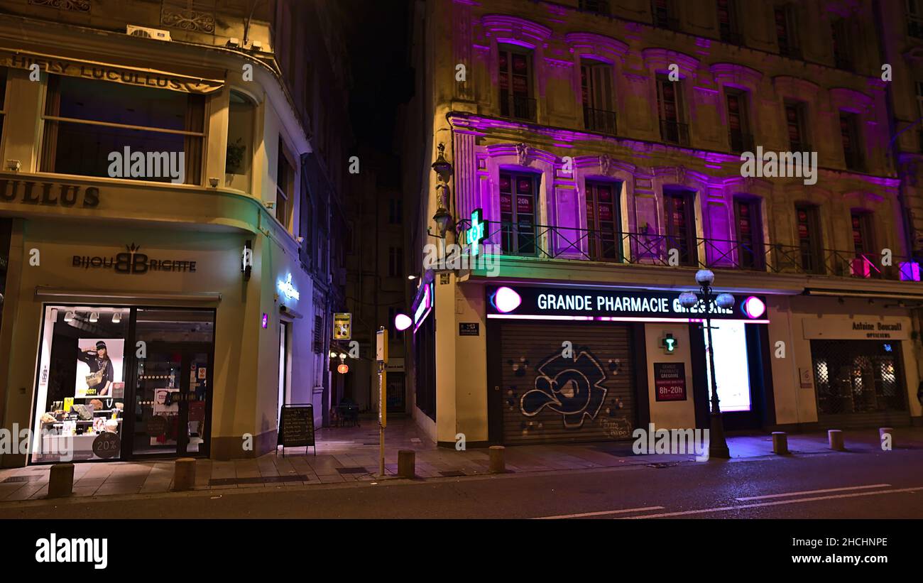 Night view of city street Rue de la Republique in the downtown of Avignon, Provence, France with Bijou Brigitte store and pharmacy. Stock Photo