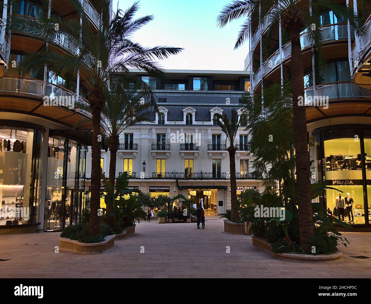 Modern apartment buildings in district Monte Carlo with luxury shops and palm trees in Principality of Monaco at the French Riviera with hotel. Stock Photo
