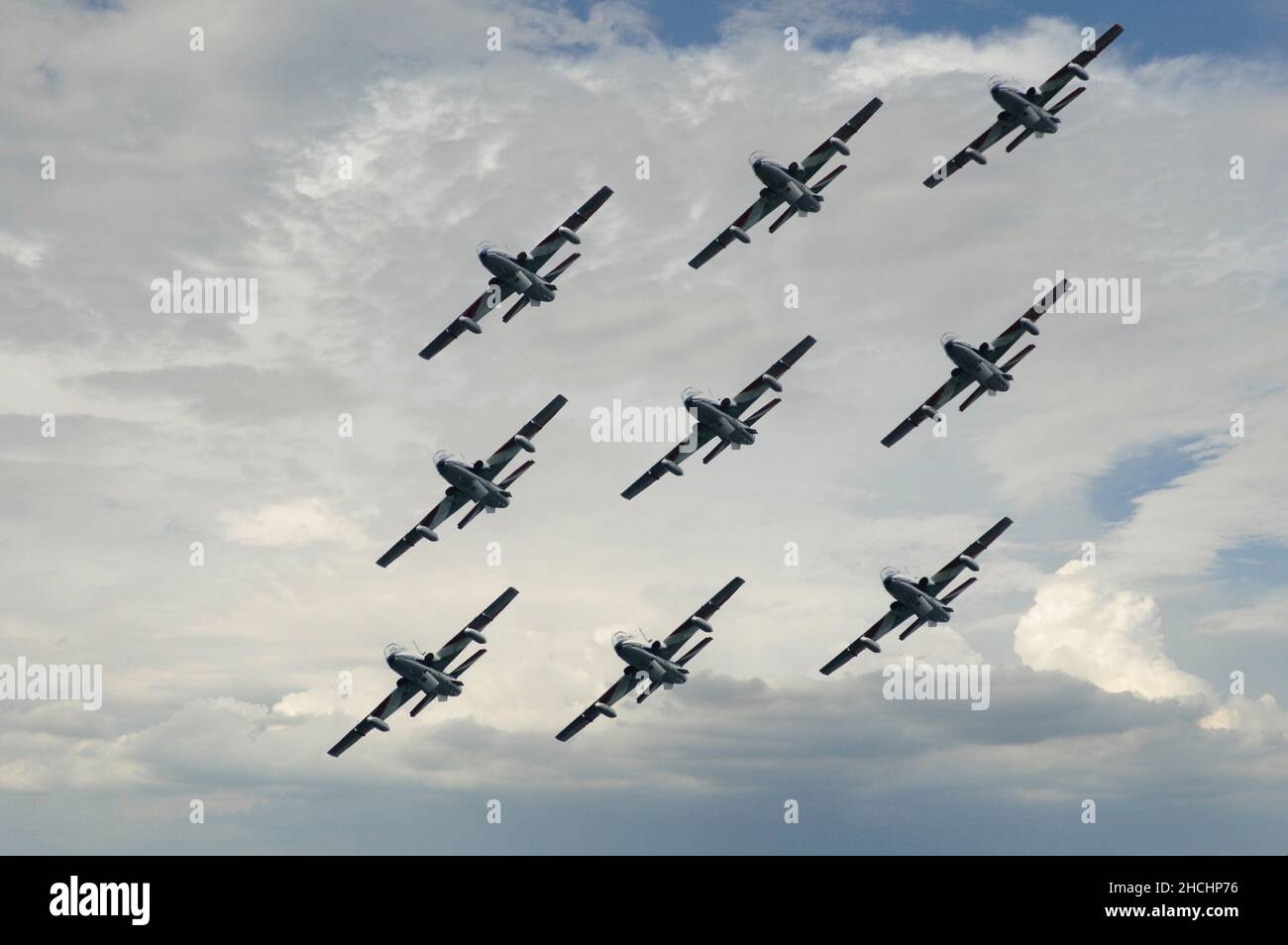 Aerobatic group of Frecce Tricolori, low angle aiew af the airplanes alying against cloudy sky Stock Photo
