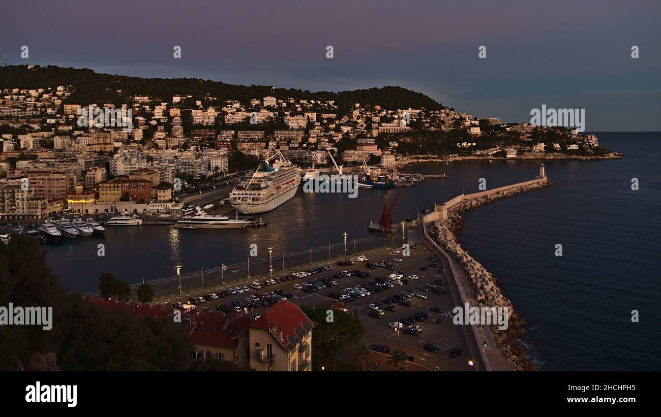 Panoramic view of harbour Port Lympia in the east of Nice, France at the French Riviera with cruse ship and residential buildings in the evening. Stock Photo