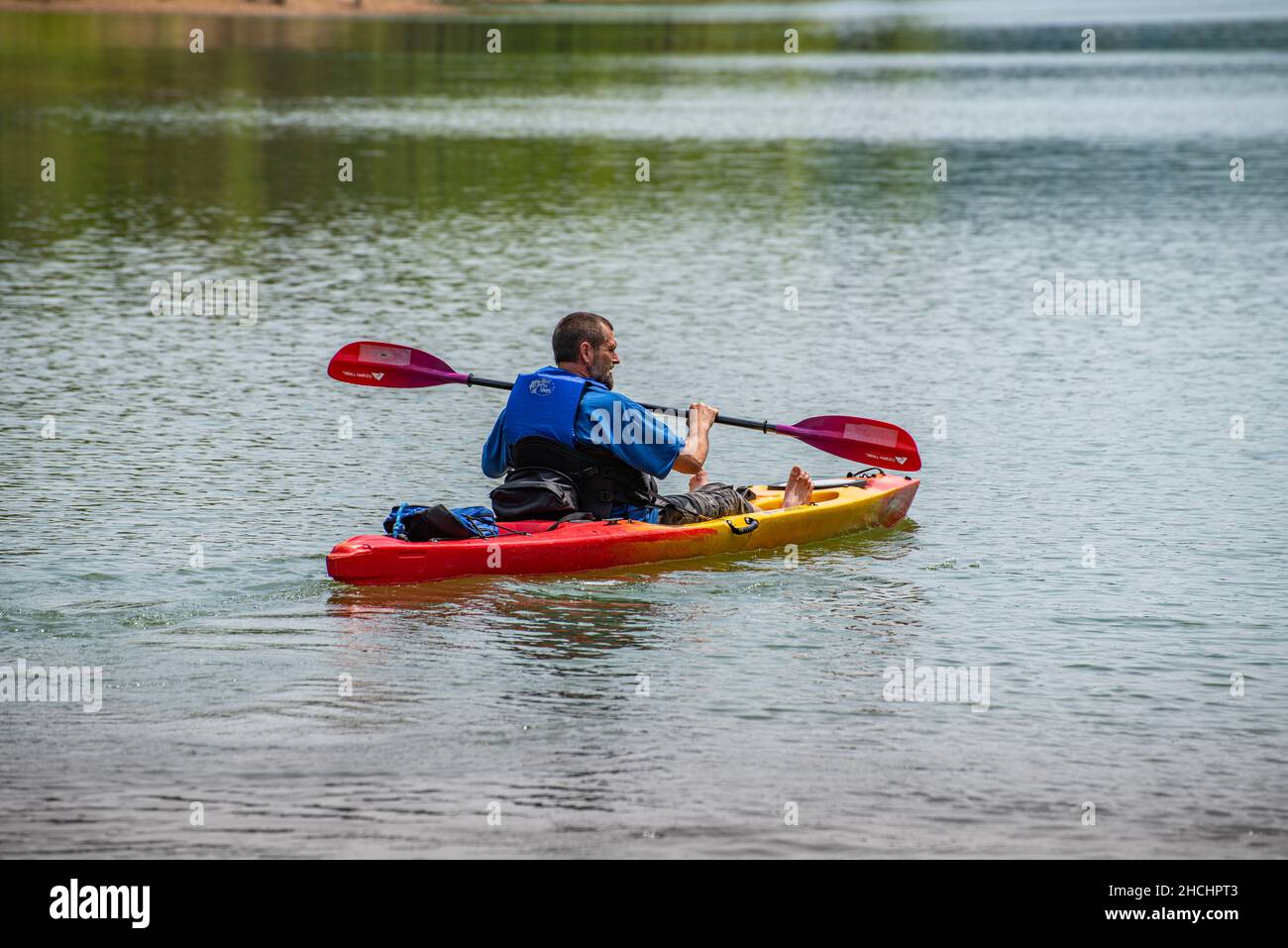 Lone man kayaking on Cave Run Lake in Kentucky Stock Photo