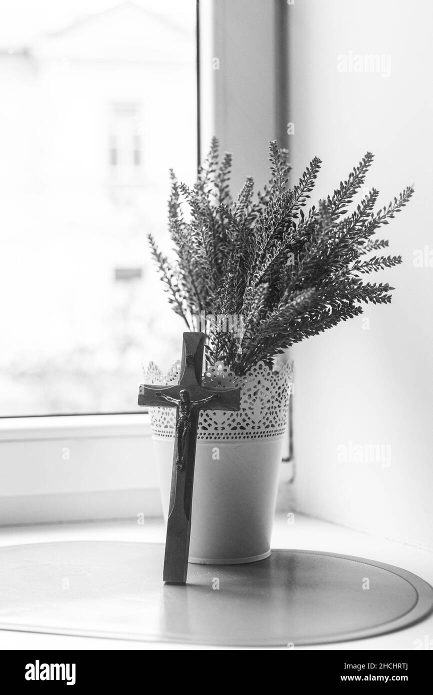 Wooden cross and lavender bouquet by the window Stock Photo