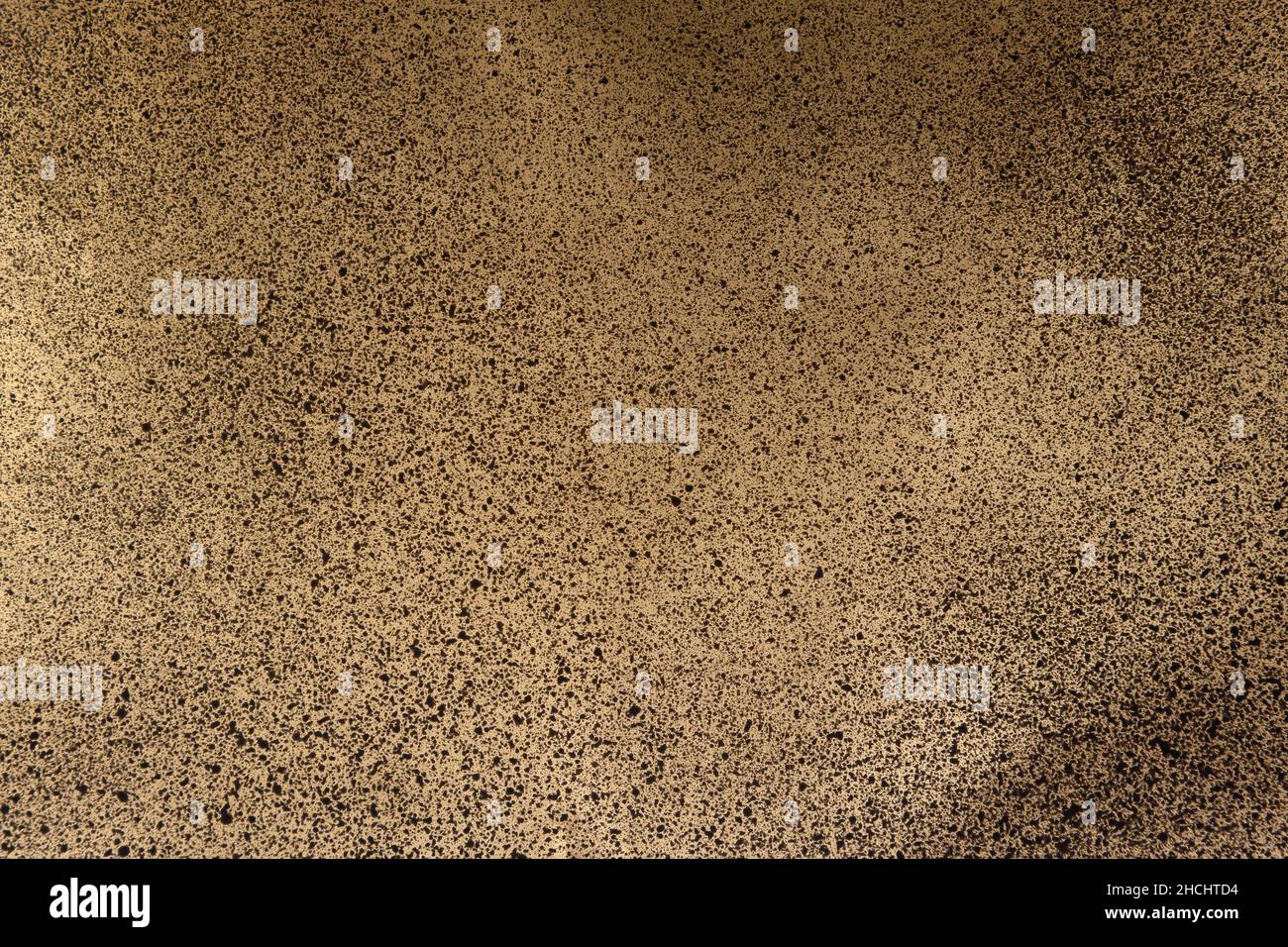 black spray paint on gold colored paper Stock Photo