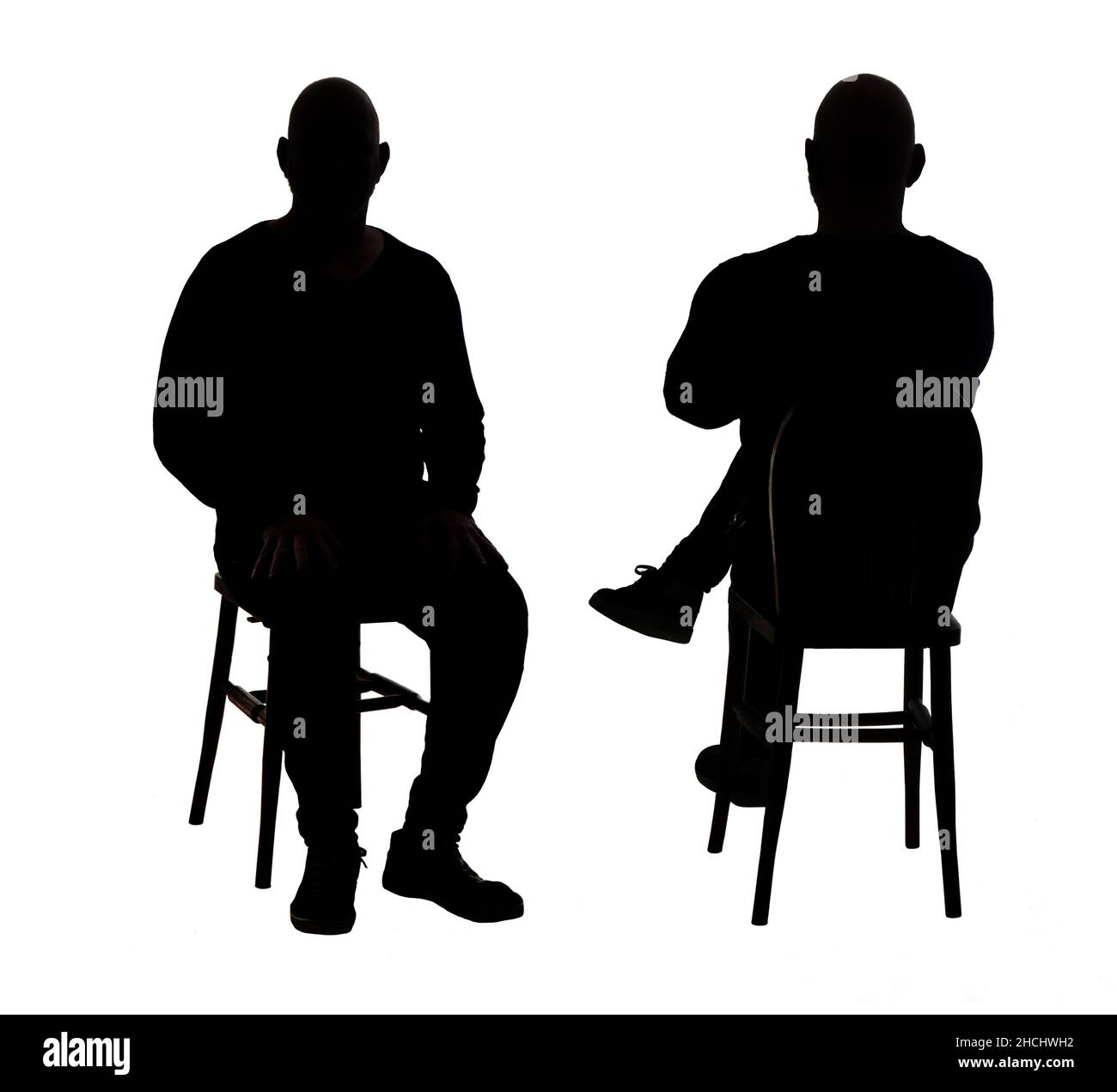 front and back of view of the silhouette of a man sitting on chair with casual clothes Stock