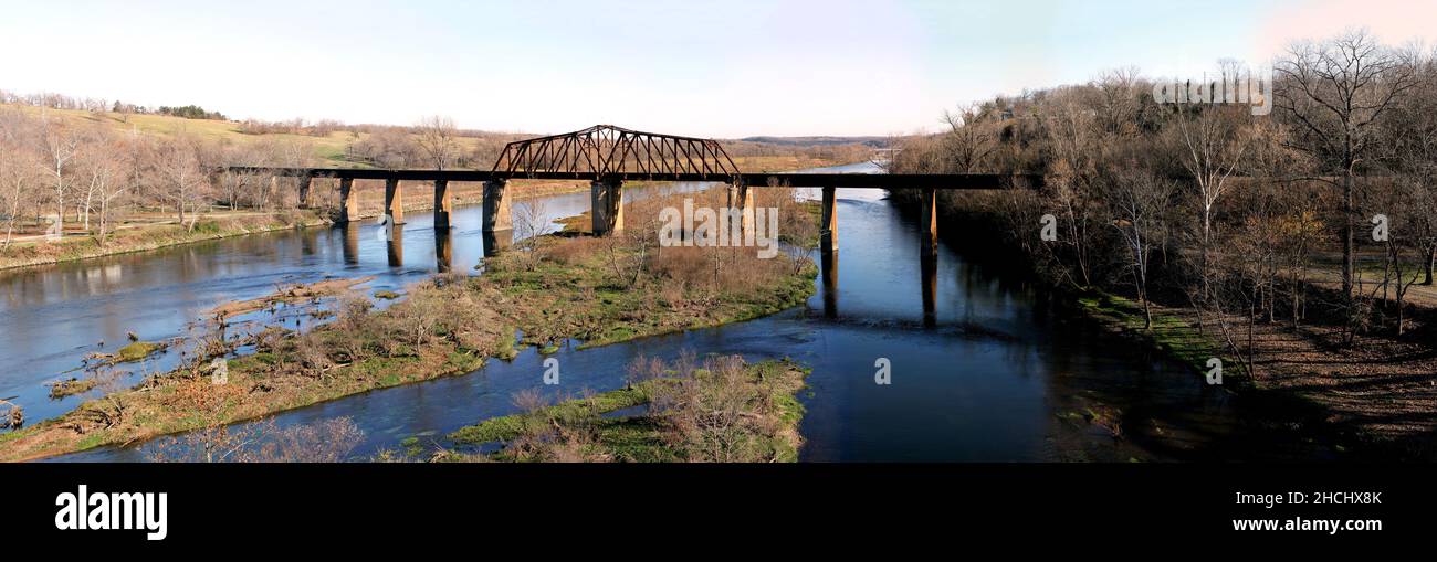 Historic iron swing bridge over the White River, near Cotter Arkansas. Old steel truss railroad bridge built in 1905, stretches 285 feet long. Stock Photo