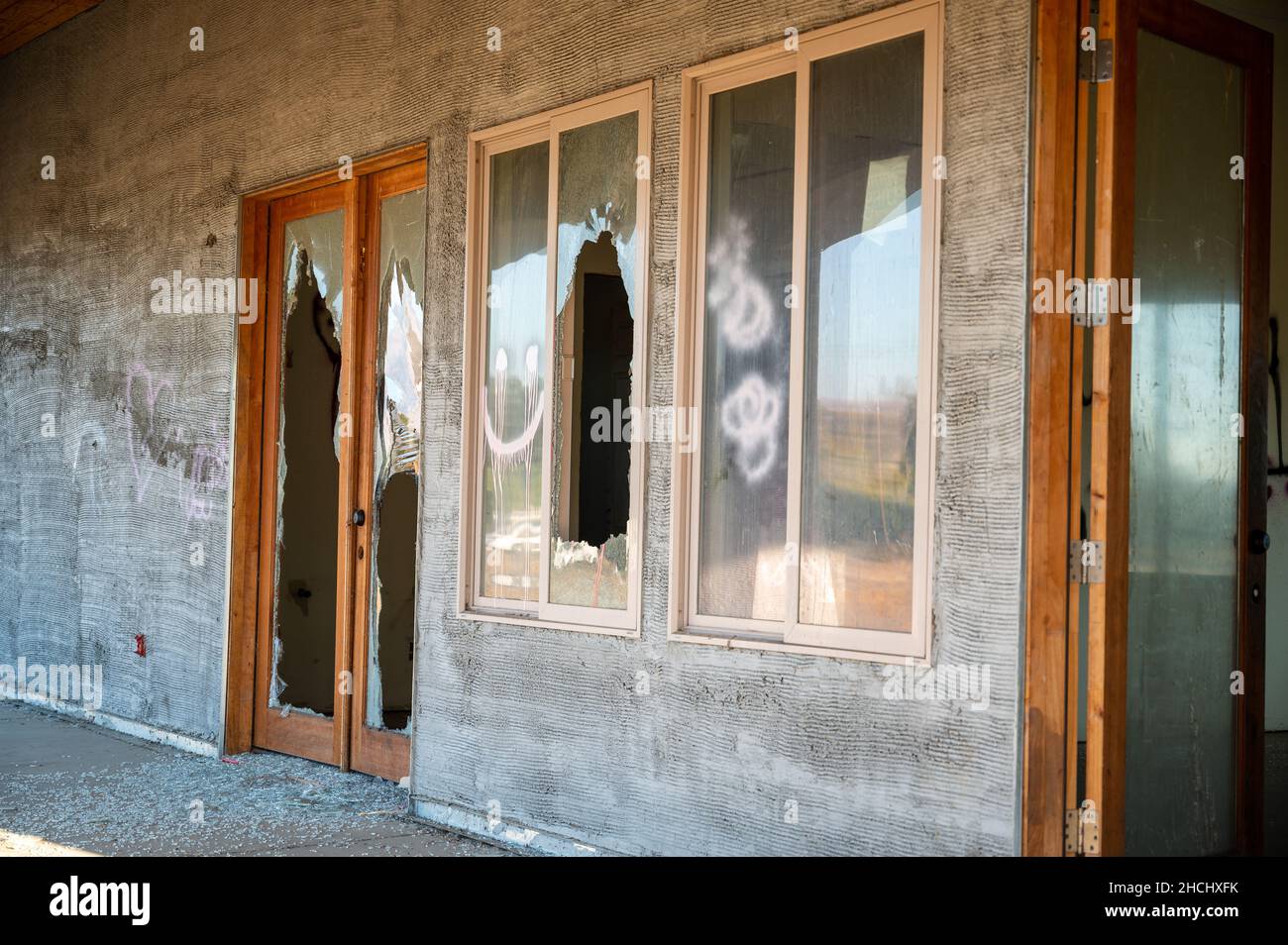 Abandoned destroyed building with broken windows in a desolated place Stock Photo