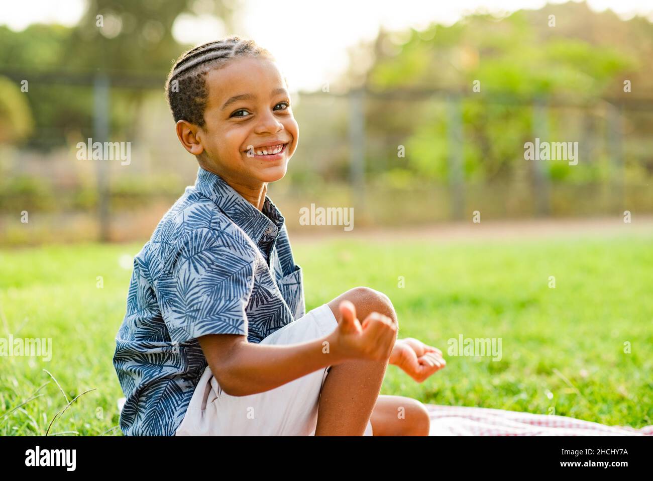 Delighted black kid smiling at camera during picnic Stock Photo