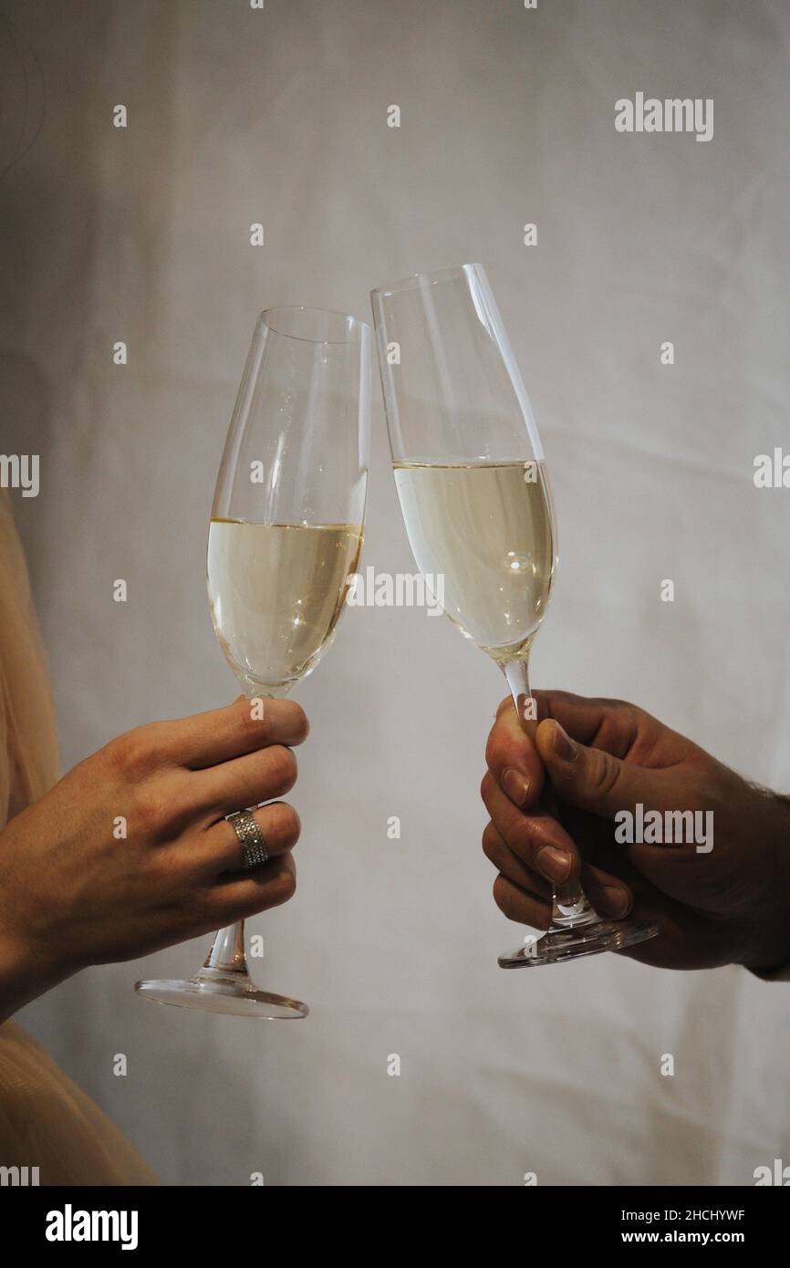 Couple hands cheering with champagne glasses Stock Photo Alamy