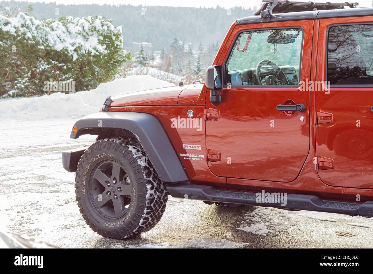 A red jeep parked in front of a louis vuitton store photo – Free