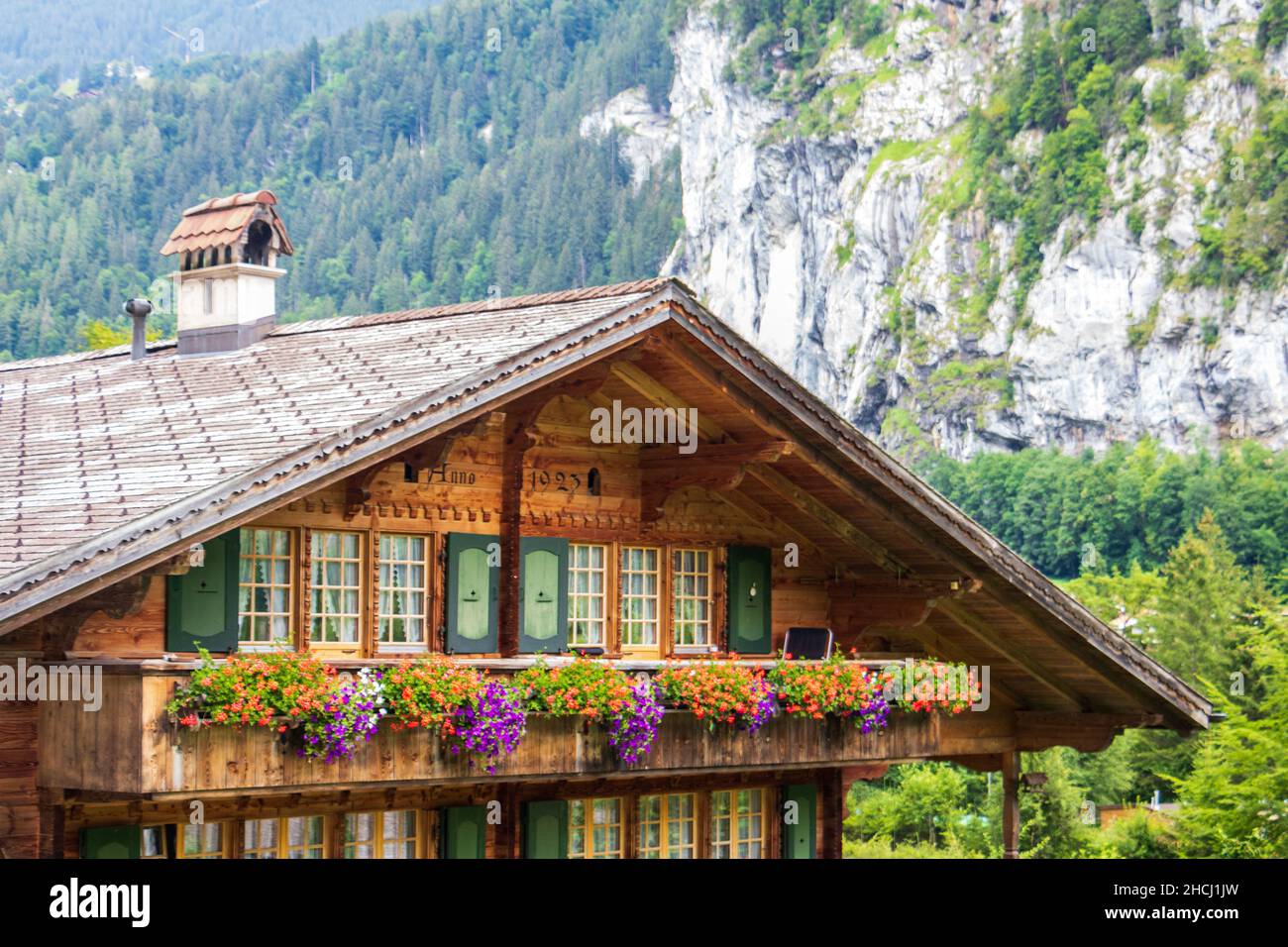 Swiss architecture wooden house with summer flowers in Lauterbrunnen valley, Switzerland, Europe Stock Photo