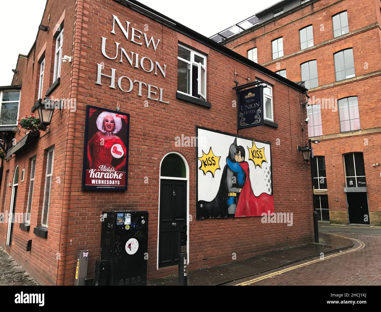 Union Hotel in the Gay Quarter of Manchester with billboard showing superman and batman kissing Stock Photo