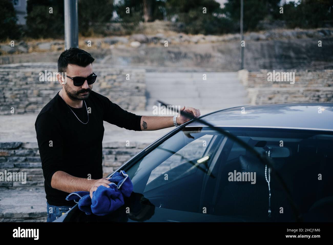 Man cleaning the car with a towel Stock Photo Alamy