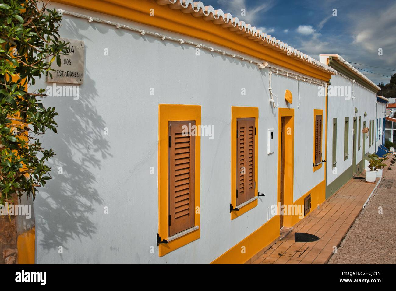 Old whitewashed fisherman's cottages with colorful doors and windows, in the former fishing village of Benagil, Algarve. Stock Photo