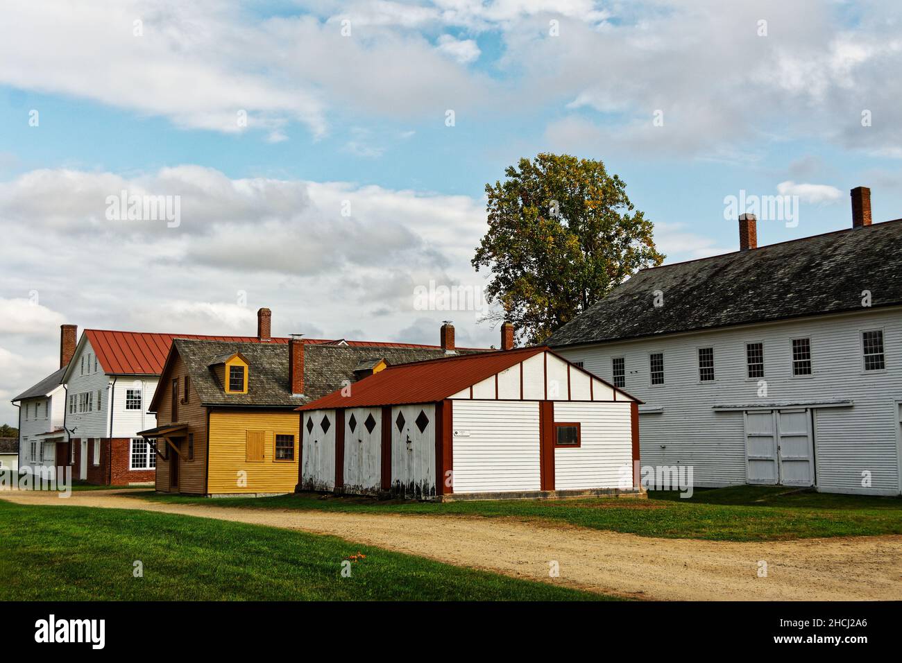 The syrup house and garage sit at the top of the hill on an overcast fall day. Canterbury Shaker Village, New Hampshire USA. Stock Photo