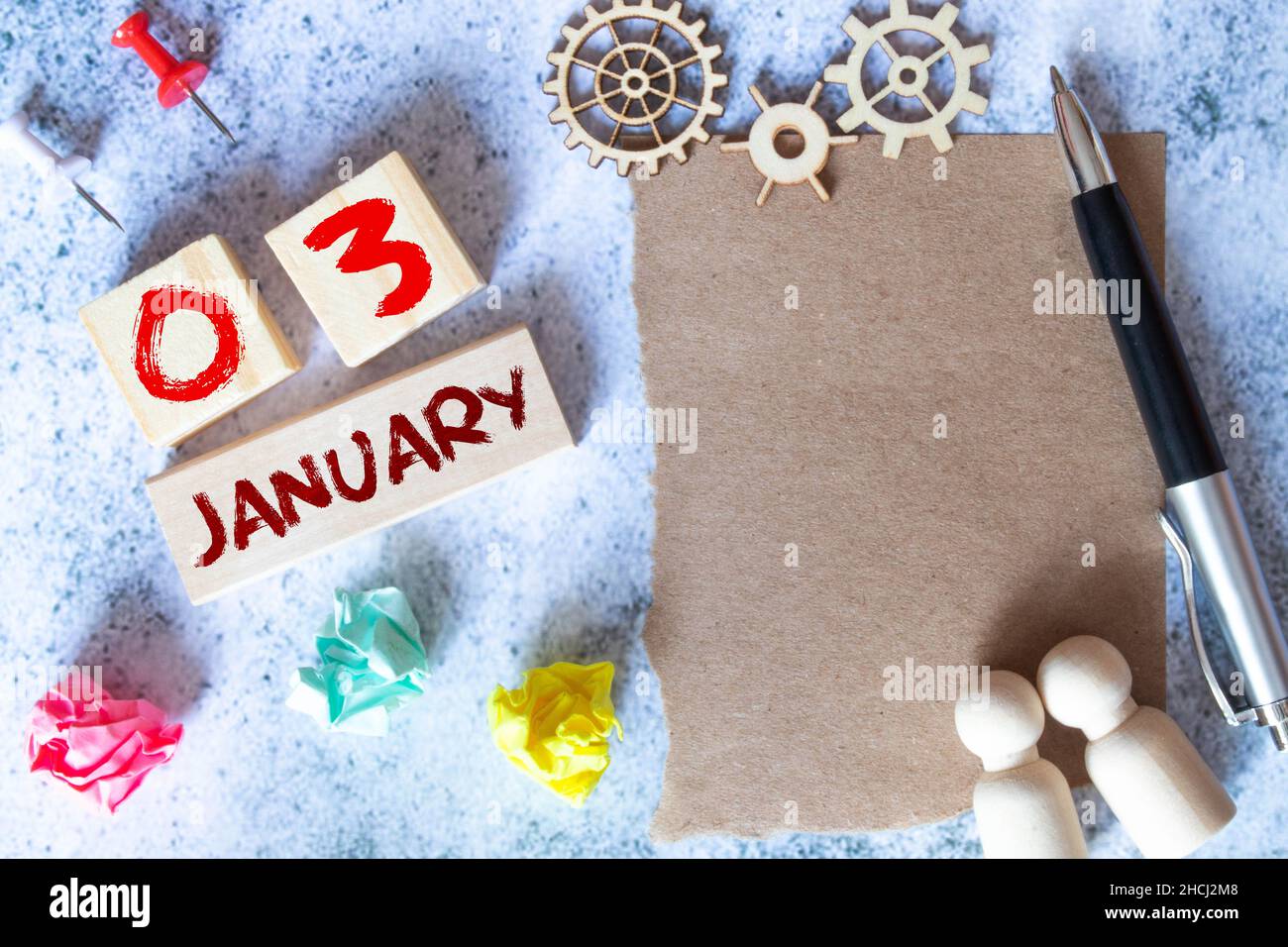 Calendar with trendy blue text and numbers for January 3 and a gift in a box. Stock Photo