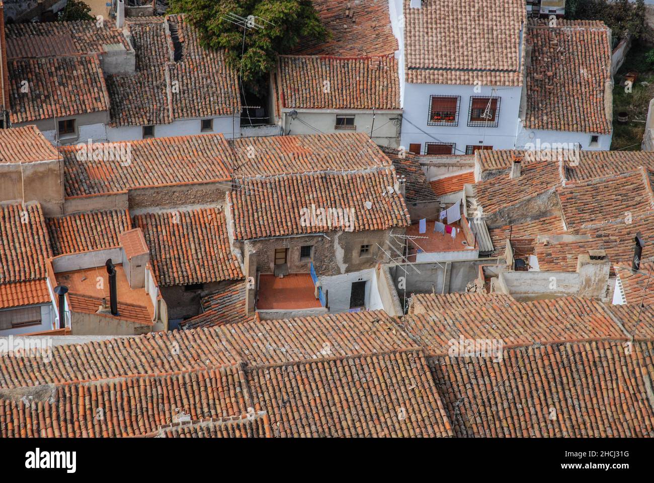 Red tiled rooftops of houses in the narrow streets of city, Almansa, Albacete Province, Spain Stock Photo