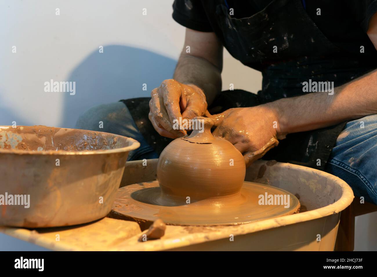 Potter making ceramic mug on the pottery wheel Stock Photo Alamy
