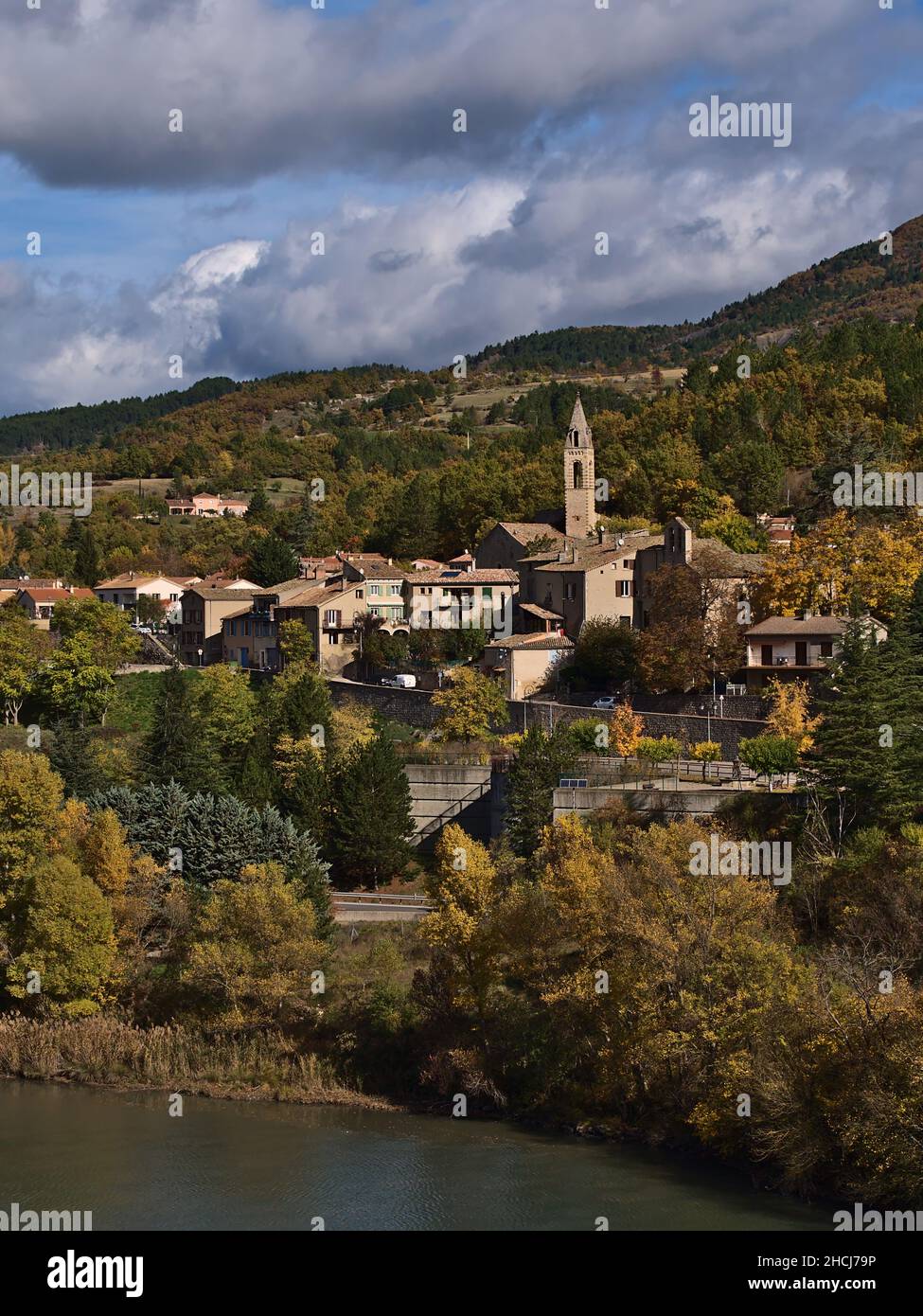 Beautiful view of small village with church and traditional buildings, part of town Sisteron, Provence, France, surrounded by colorful trees in autumn. Stock Photo