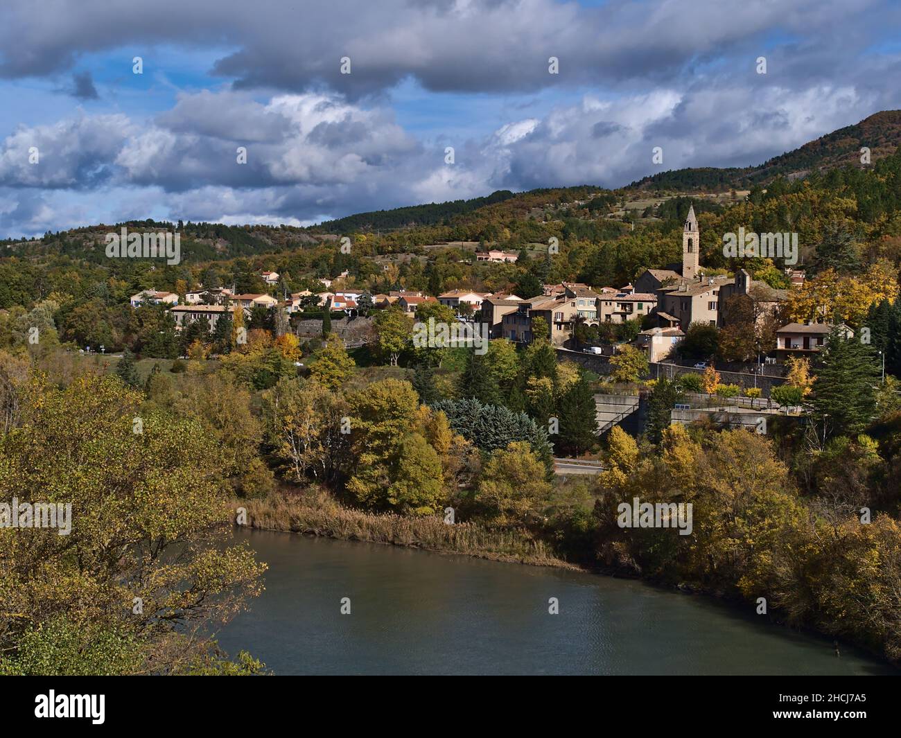 Beautiful view of the north of town Sisteron in Provence, France with church and traditional houses surrounded by colorful trees in autumn season. Stock Photo