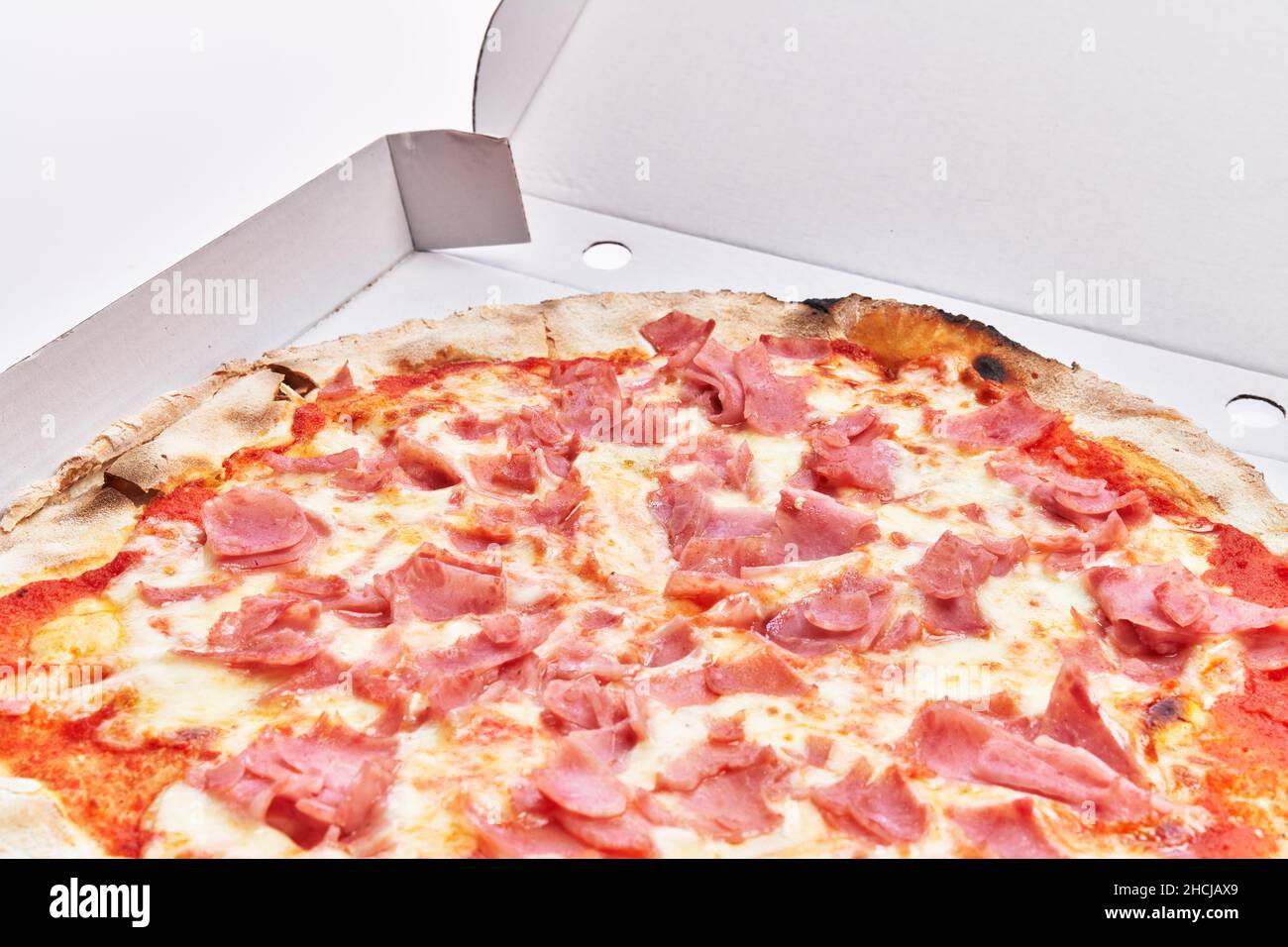 Single prosciutto italian pizza on delivery box isolated over white background Stock Photo Alamy