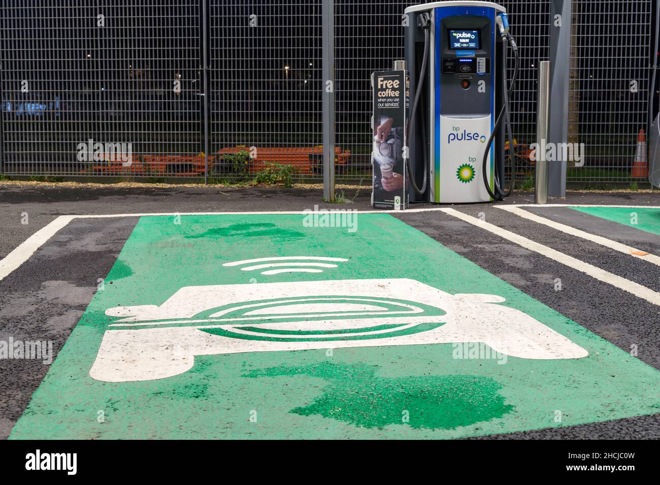 EV logo painted on the parking bay for EV Charging point supplied by BP Pulse London England UK Stock Photo