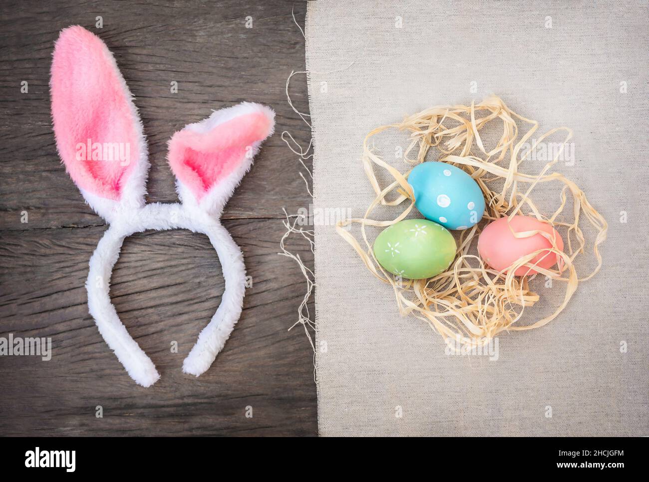 Bunny ears and Easter eggs on wooden background Stock Photo