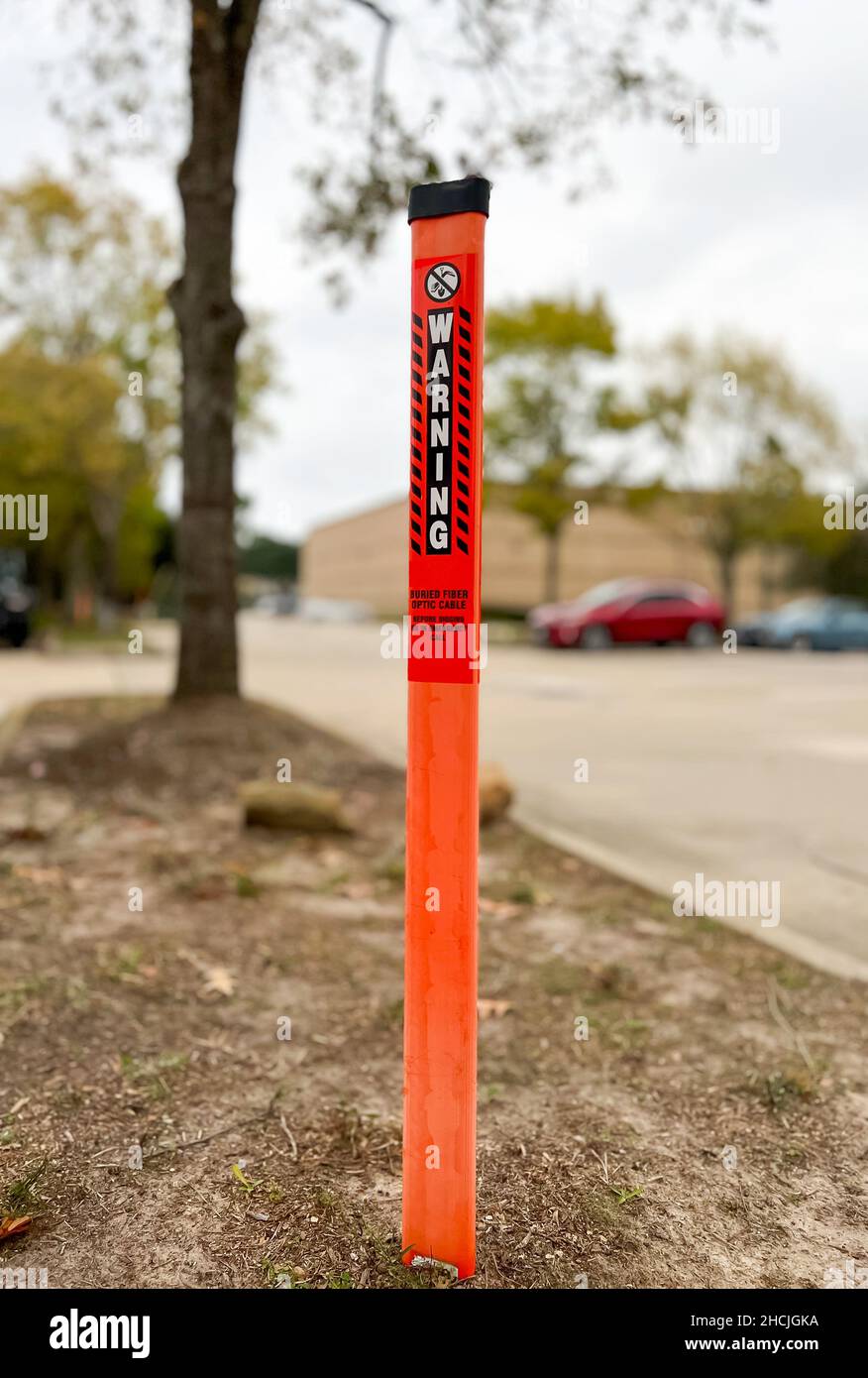 Orange warning signs pole on thr ground , be careful before digging. Stock Photo