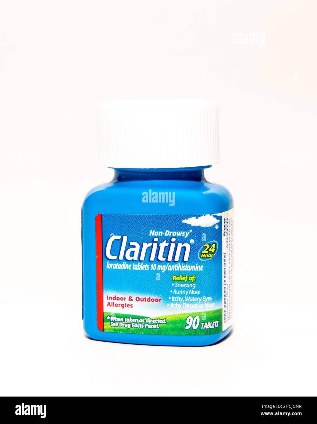 A blue bottle of 90 Claritin, loratadine tablets a non drowsy antihistamine for indoor and outdoor allergy relief isolated on white. Stock Photo