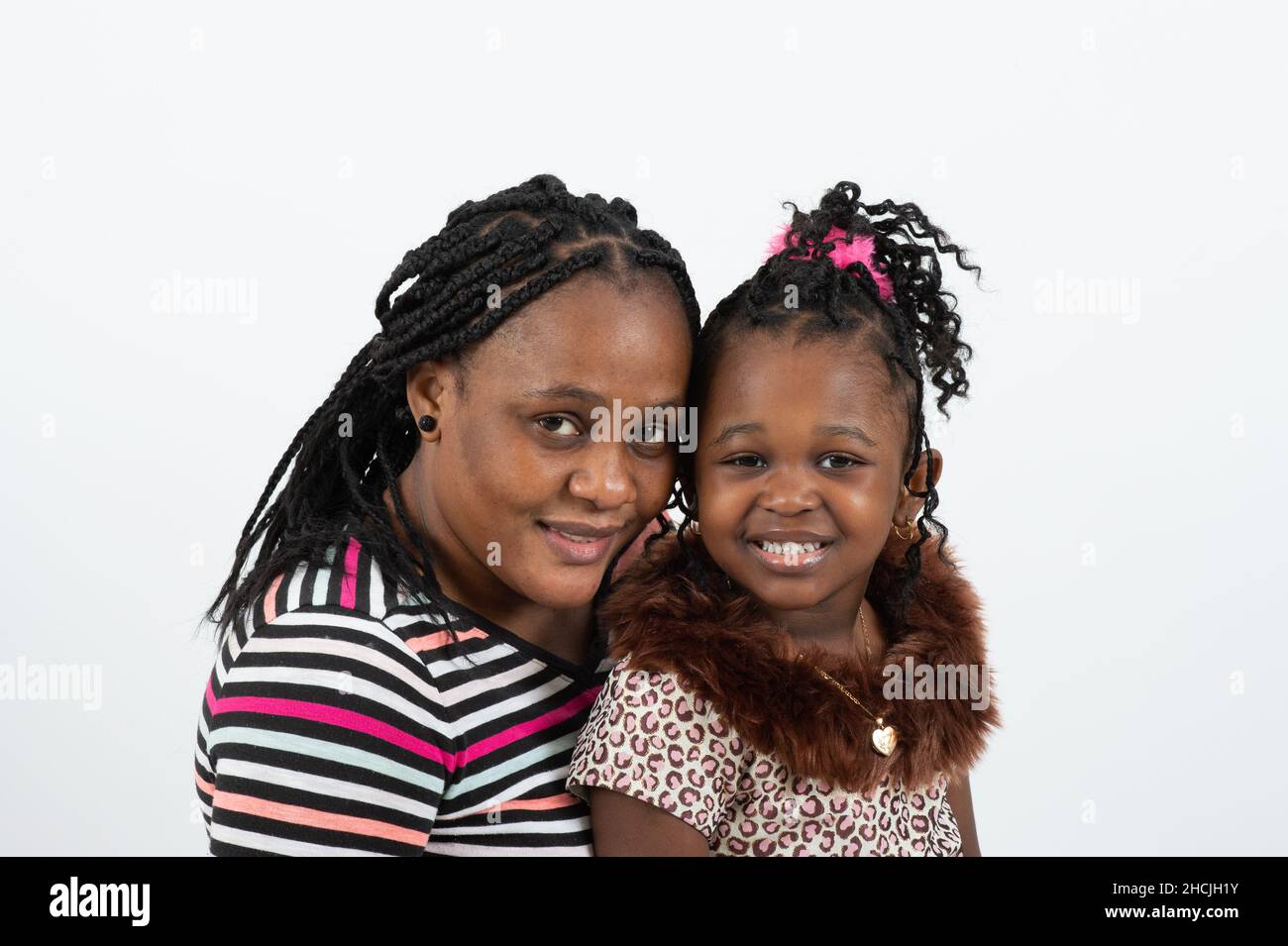 Closeup portrait of 4 or 5 year old girl with her mother, white background Stock Photo