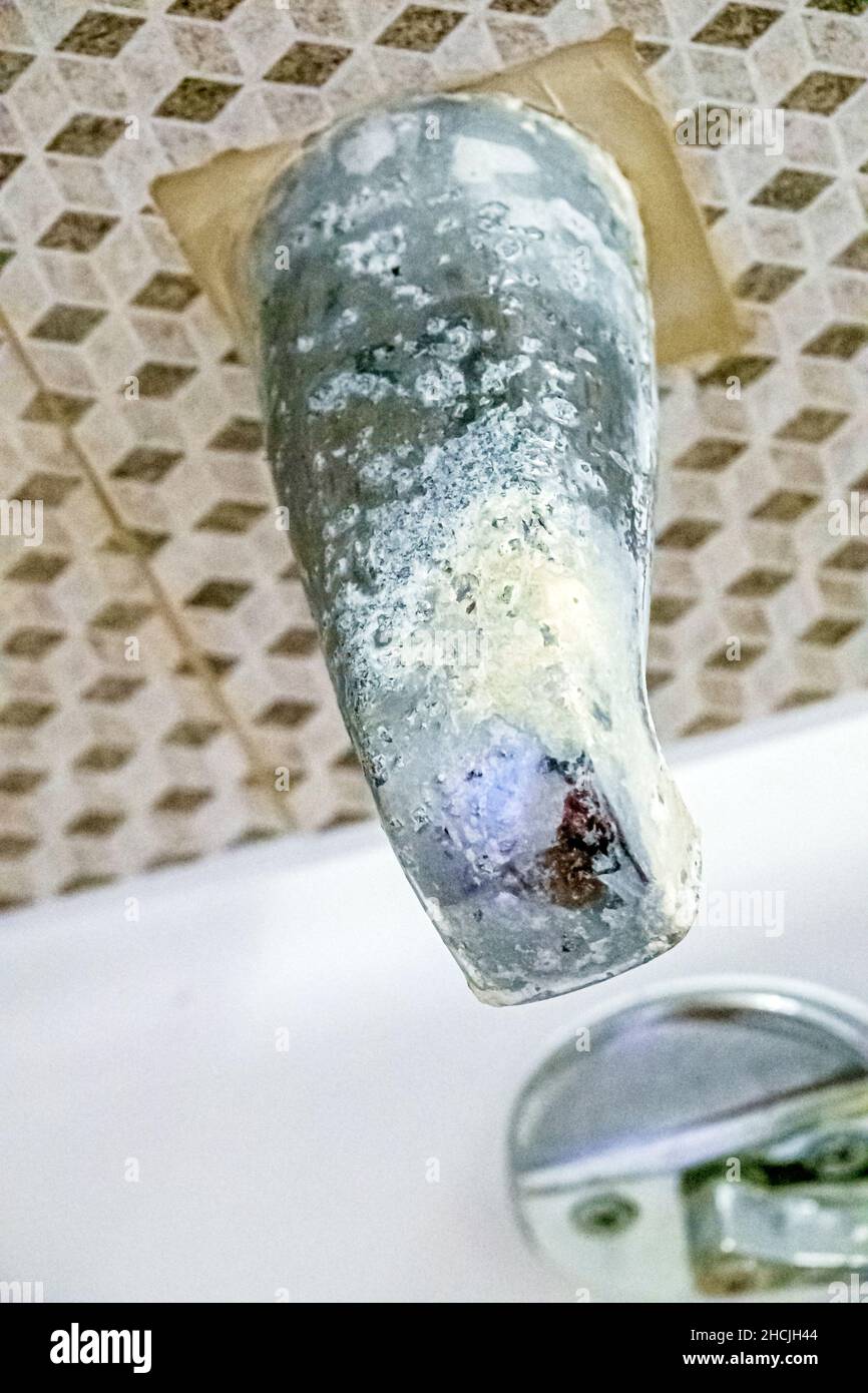 Miami Beach Florida bath tub spout faucet corroded damaged pitted worn out needing replacement Stock Photo