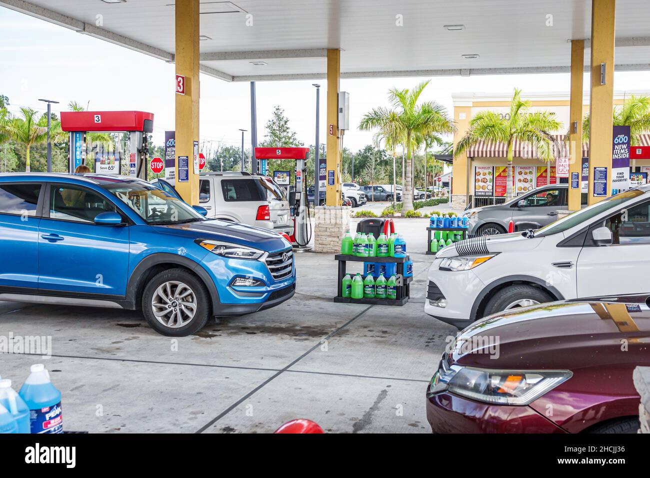 Vero Beach Florida Murphy Gas Station petrol pumps self-service cars vehicles filling up covered Stock Photo