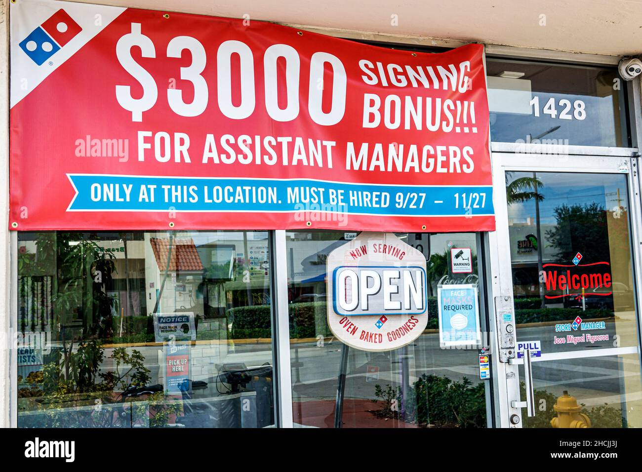 Miami Beach Florida Domino's Pizza exterior entrance sign $3000 signing bonus assistant managers job opening openings employment offered incentive now Stock Photo