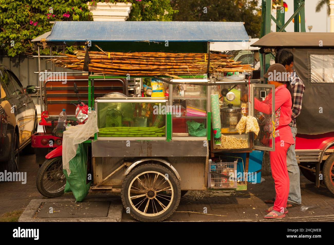 sunlit pushcart / sugar cane juice vendor near the riverside during