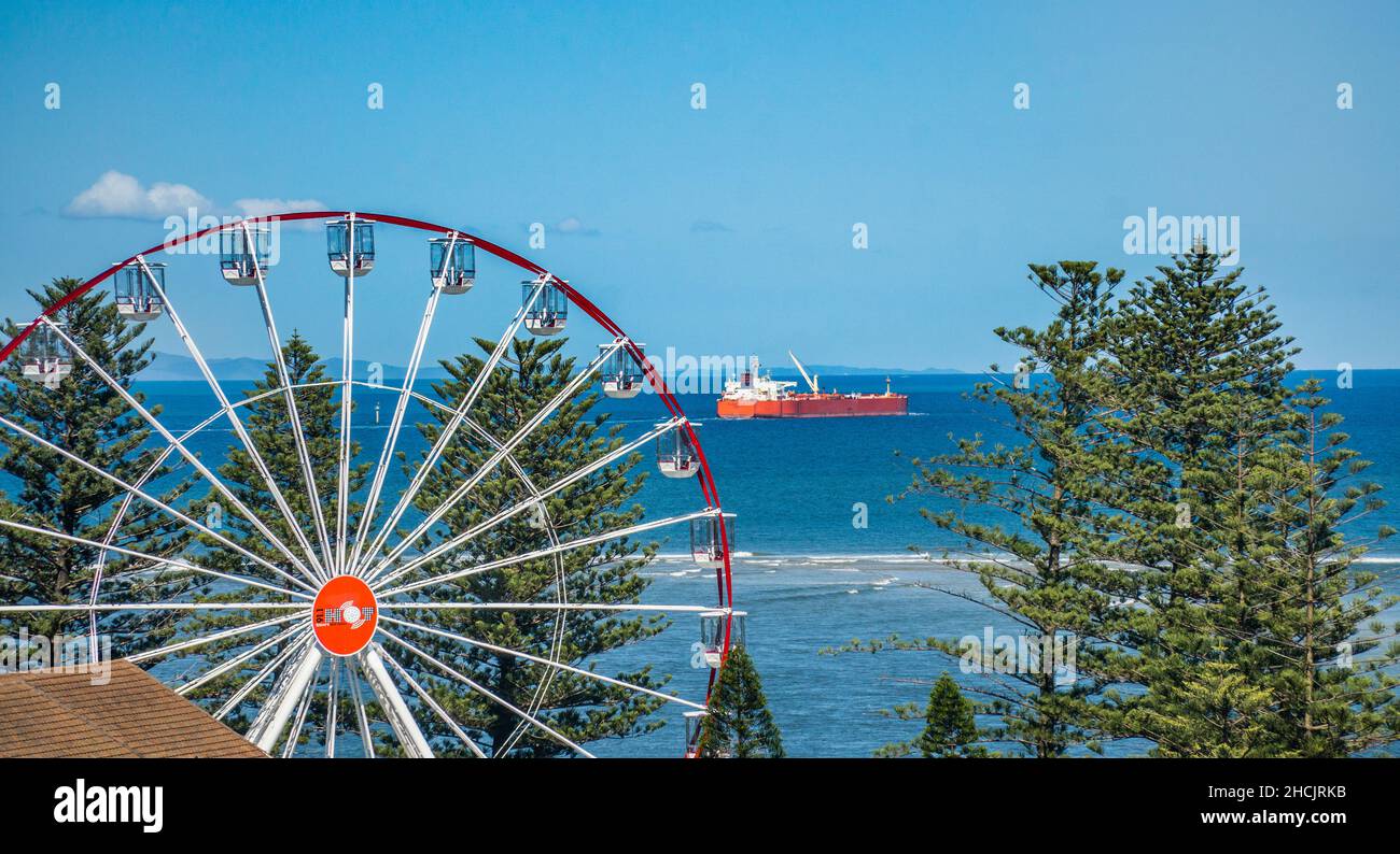 Crude Oil Tanker STAVANGER FALCON passing the Caloundra waterfront with Skyline Ferris Wheel in the foreground, Caloundra, Sunshine Coast Region, Sout Stock Photo