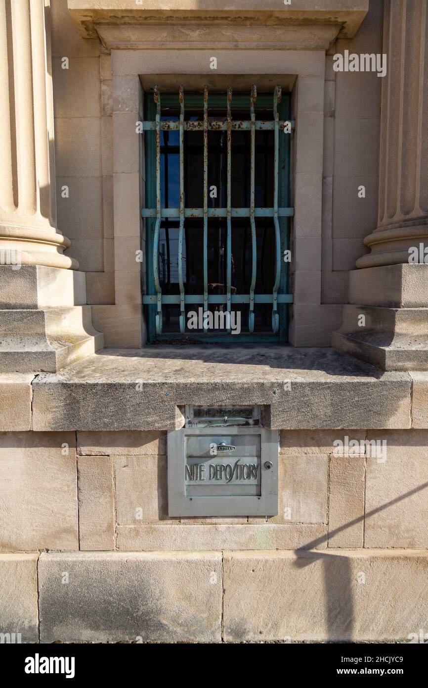 The Guardian night (nite) depository below a barred window between the columns of the former Studabaker Bank building in Bluffton, Indiana, USA. Stock Photo