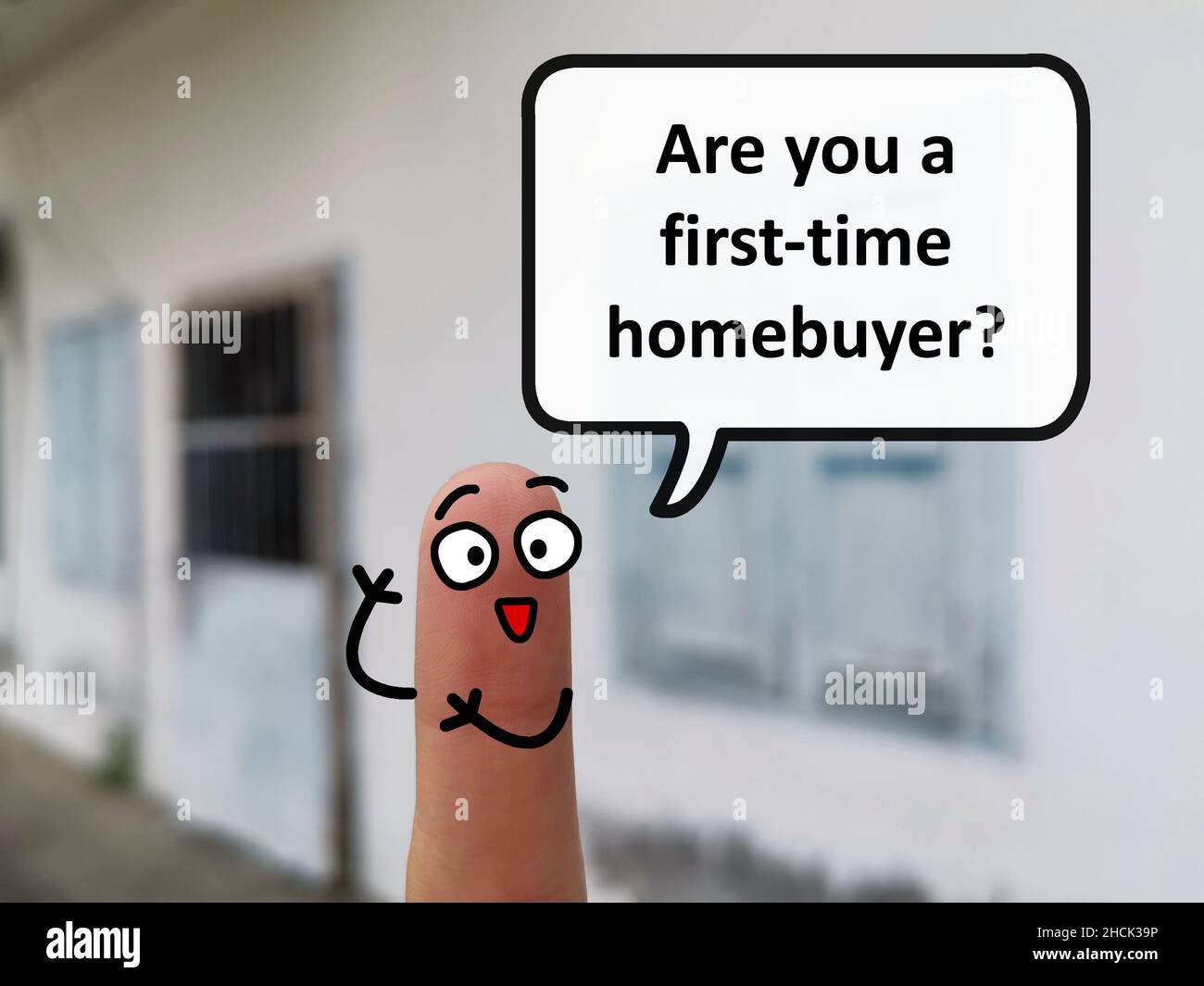 Two fingers are decorated as one person. He is asking if you are a first time homebuyer. Stock Photo