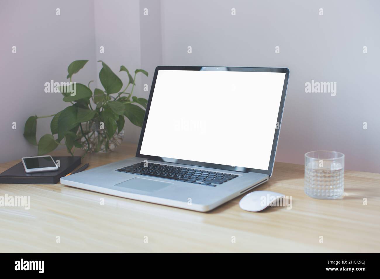 workplace in the corner, computer, mouse, water on the table Stock Photo